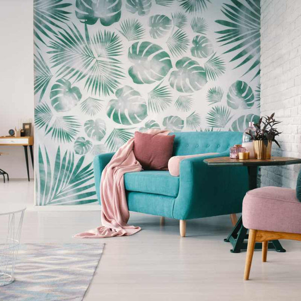 Living room with a white brick wall, light blue couch, and wall with green arboreal wallpaper